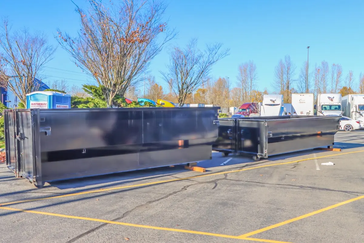 Professional dumpster rental service with roll-off container on residential driveway in Aspen